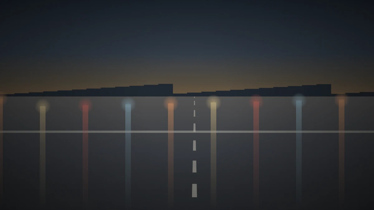 夕暮れの交差点で濡れた路面に信号や車の灯りが映っている様子