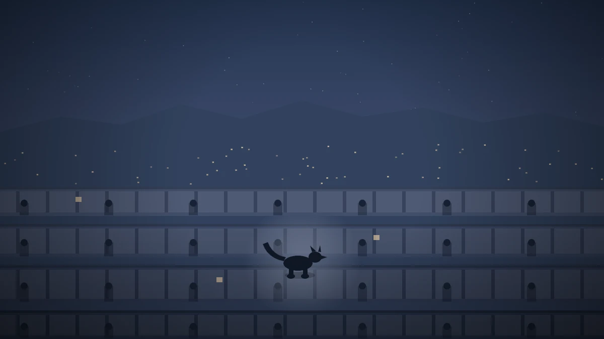 夜の造成団地。石積みの擁壁が段々に連なり、その縁を横に歩く猫